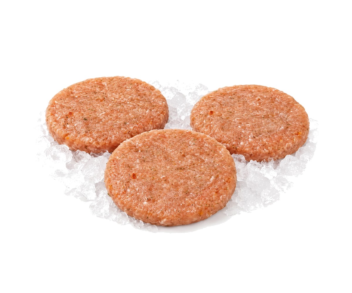 Hamburguesas de pechuga de pollo crudas sobre hielo